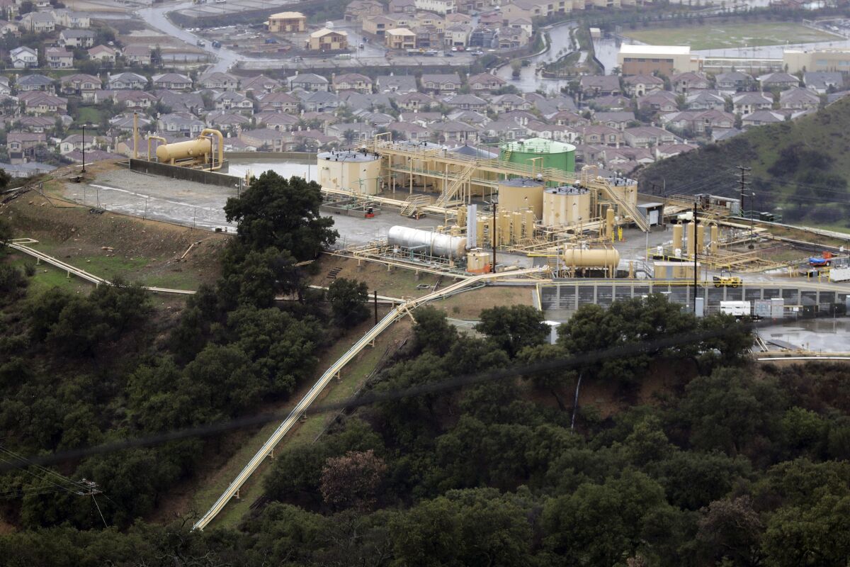 FILE - This Jan. 12, 2017 file photo, shows a gas gathering plant on a hilltop at the Southern California Gas Company's Aliso Canyon storage facility in Los Angeles. The California Public Utilities Commission fined SoCalGas $10 million on Thursday, Feb. 3, 2022, for improperly using ratepayer money on advocacy work around energy efficient building codes. The ruling also requested the utility to reimburse customers for misspent funds. (AP Photo/Jae C. Hong, File)