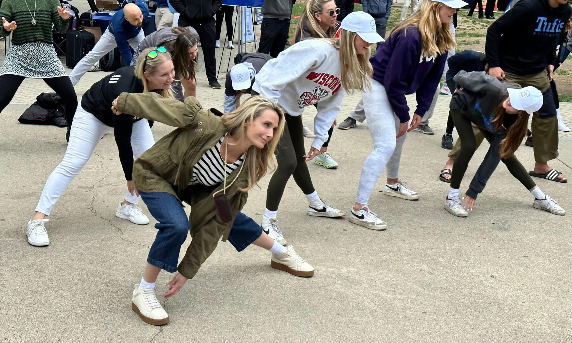 Jennifer Siebel Newsom exercising on concrete with a crowd
