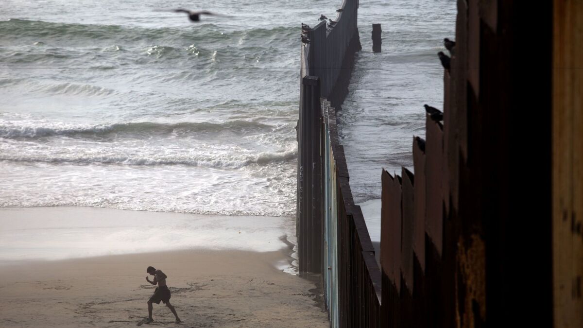 The existing U.S.-Mexico border wall extends into the ocean at Playas de Tijuana, separating California from Baja California.