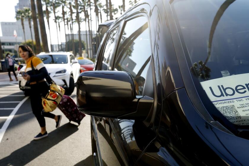 LOS ANGELES, CA February 25, 2019: Kristine Valenzuela quickly exits an Uber at Union Station in Los Angeles, CA February 25, 2019. Transportation officials are considering a tax on Uber and Lyft rides in Los Angeles County, saying the Silicon Valley companies make congestion worse in a traffic-choked region and run a business on public streets without chipping in to improve them. The ride-hailing tax is in the early stages of discussion at the Metropolitan Transportation Authority, along with more than a dozen other strategies to manage congestion and fund transportation projects before the 2028 Olympic Games. (Francine Orr/ Los Angeles Times)