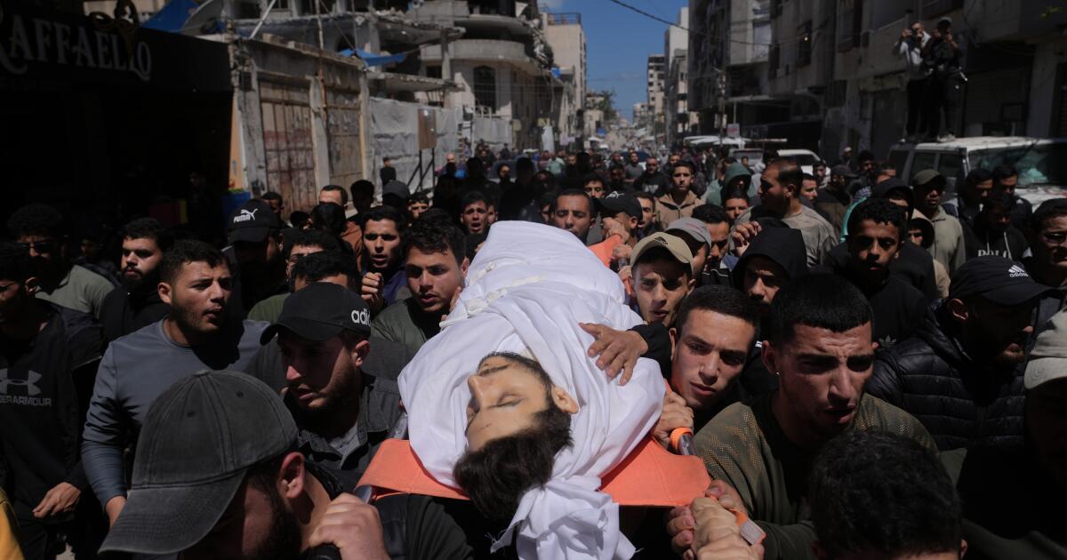 Mourners carry the body of Azzam al-Hayya, son of Hamas leader Khalil al-Hayya, mourn over his body after he was killed in an Israeli airstrike, at Shifa Hospital in Gaza City Thursday, May 7, 2026. (AP Photo/Jehad Alshrafi)