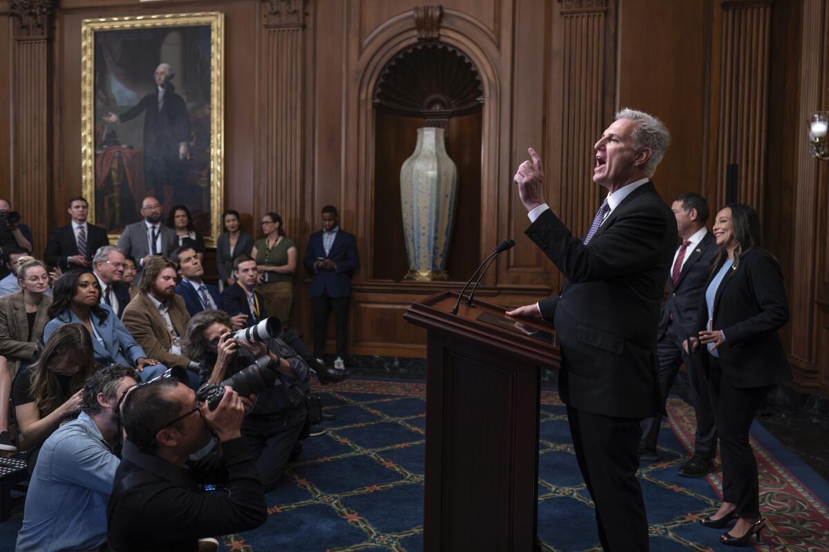 House Speaker Kevin McCarthy stands in front of reporters.