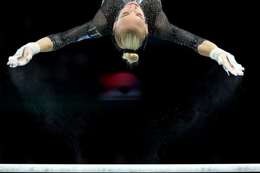 PARIS, FRANCE July 28, 2024-Italy's Alice D'Amato competes on the uneven bars during qualifying for women's team gymnastics at the 2024 Olympics in Paris, France Sunday(Wally Skalij/Los Angeles Times)