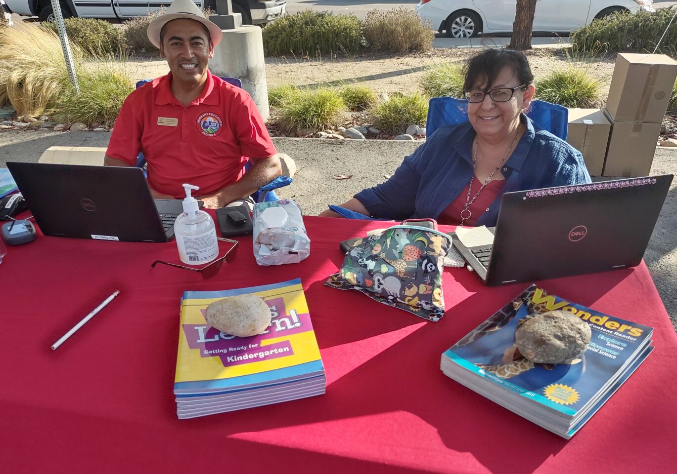 San Diego County Office of Education representatives Trino Sandoval, left, and Angelica Quezada hand out educational information and promoted reading and learning.