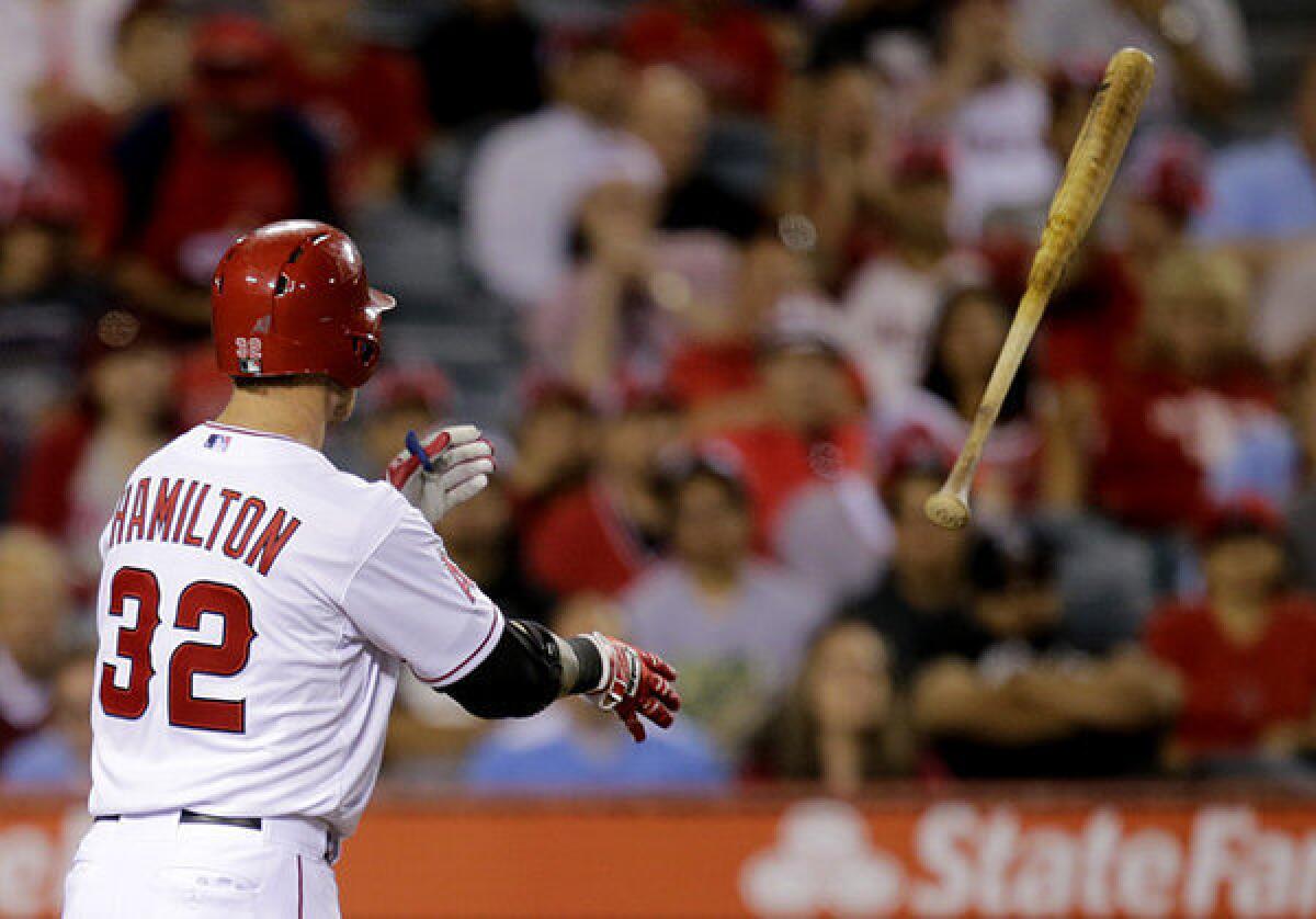 Angels' Josh Hamilton tosses his bat after striking out in the seventh inning of Tuesday's game against the Seattle Mariners.