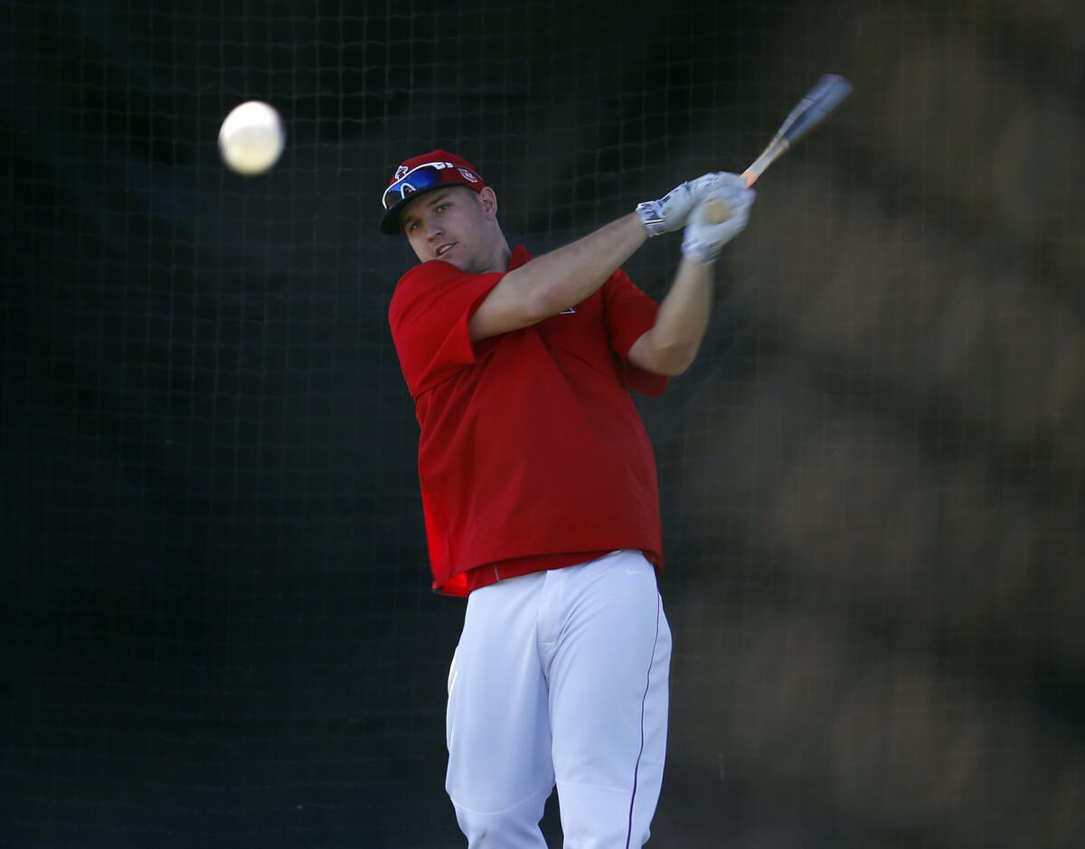 Angels outfielder Mike Trout works on curve balls in the batting cage during spring training.
