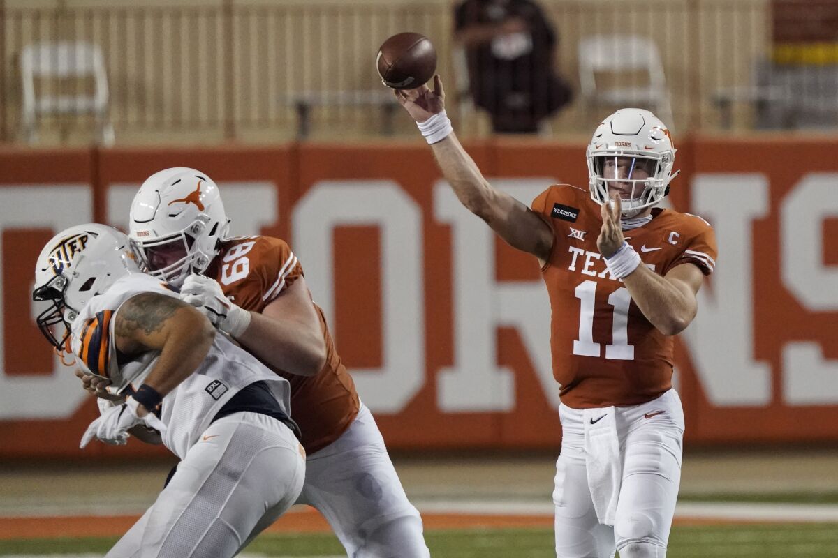 Texas' Sam Ehlinger (11) throws a pass against UTEP during the first half of an NCAA college football game in Austin, Texas, Saturday, Sept. 12, 2020. (AP Photo/Chuck Burton)