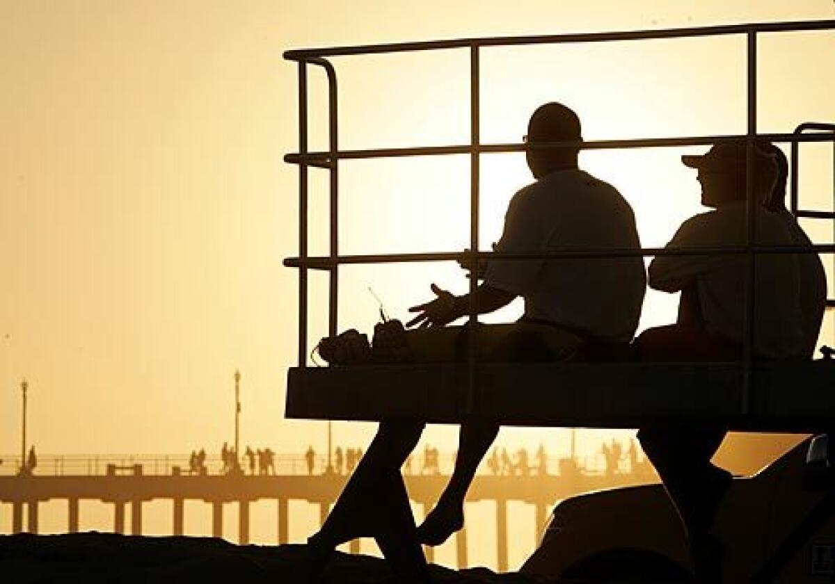 Lobdell takes in the sunset with Huntington Beach lifeguards after a long day spent recapturing the magic of his summer stints on the beach 25 years ago.