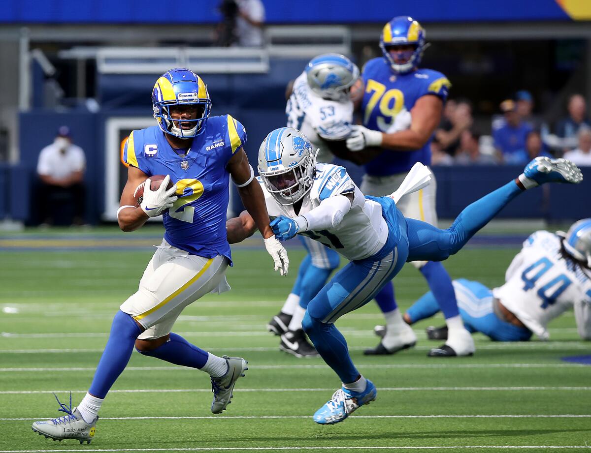 Rams wide receiver Robert Woods turns upfield after making a catch against Lions safety Tracy Walker.