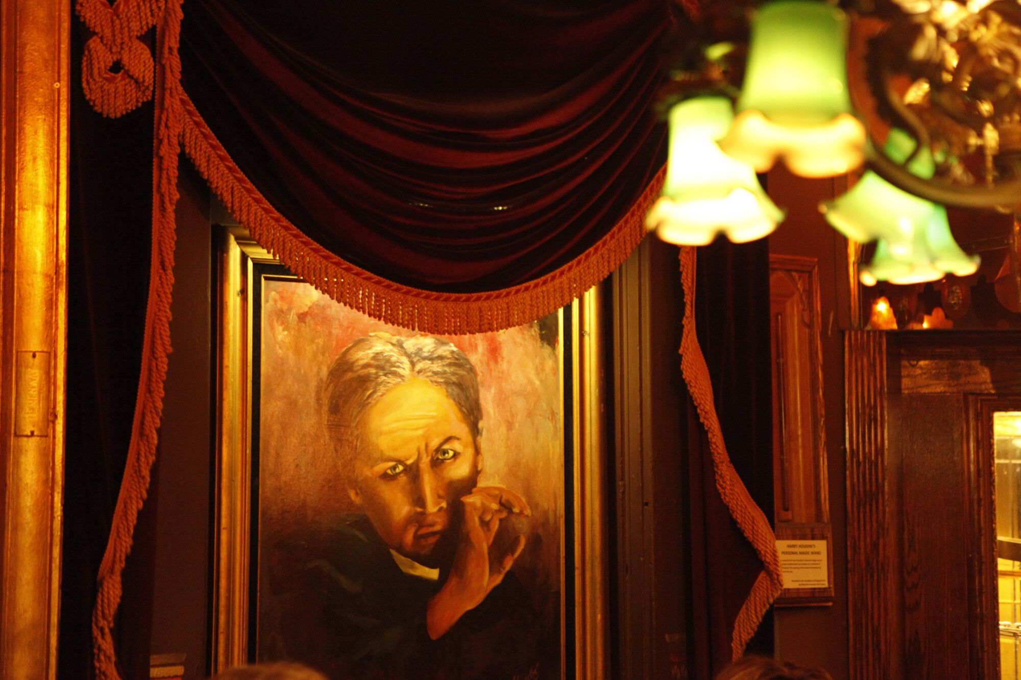 A portrait of Harry Houdini on the wall of a dining room in the Magic Castle.