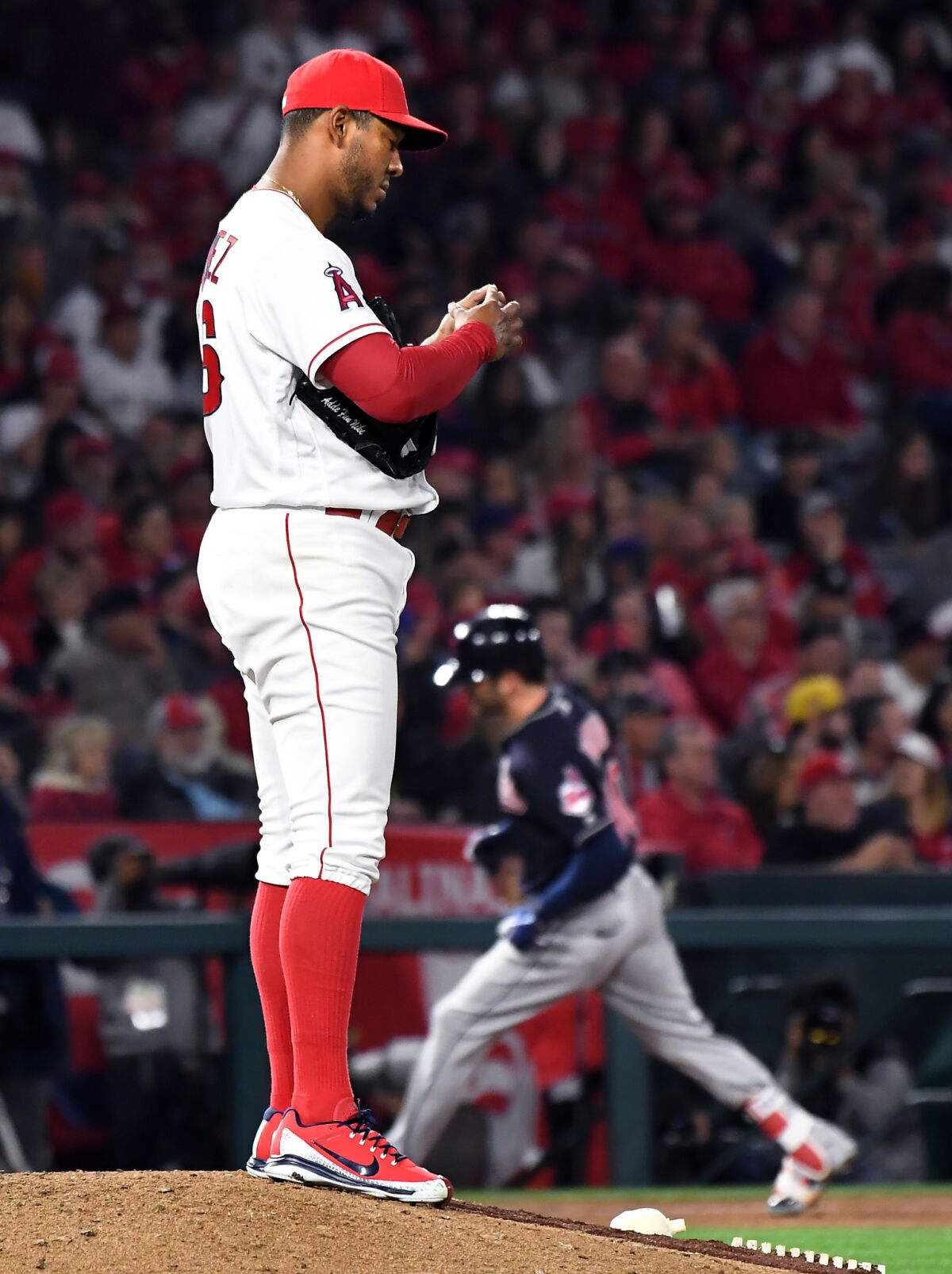 Angels pitcher J.C. Ramirez stands on the mound as Indians batter Tyler Naquin rounds the bases on a two-run home run in the 4th inning.