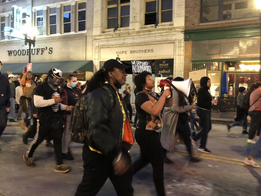 Protesters march through a street.