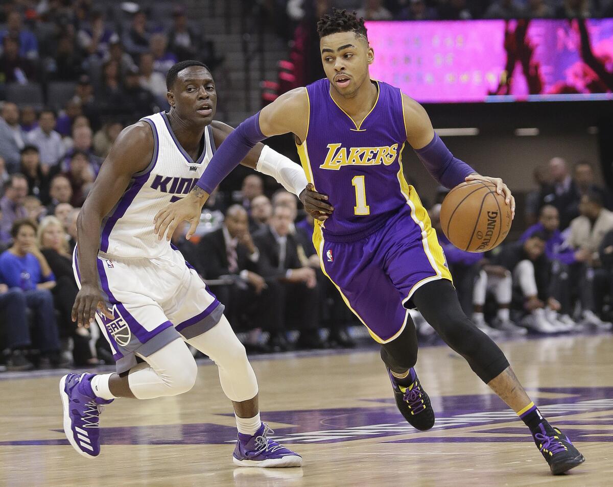 Lakers guard D'Angelo Russell (1) drives against Sacramento Kings guard Darren Collison during the first half on Dec. 12.
