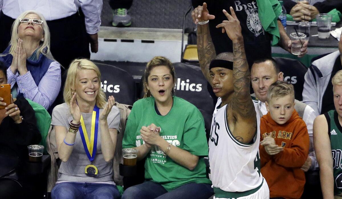 Boston Celtics guard Isaiah Thomas reacts in front of fans, including Boston Marathon bombing survivor Adrianne Haslet, applauding at left, in Game 3 of a first-round NBA basketball playoff series on Friday.