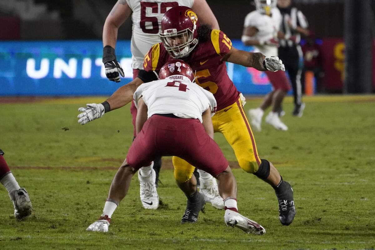 USC safety Talanoa Hufanga, right, sacks Washington State quarterback Jayden de Laura.