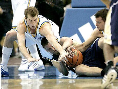 UCLA forwards Michael Roll, left, and Nikola Dragovic, right, scramble for a loose ball with Irish forward Zach Hillesland in the first half Saturday.