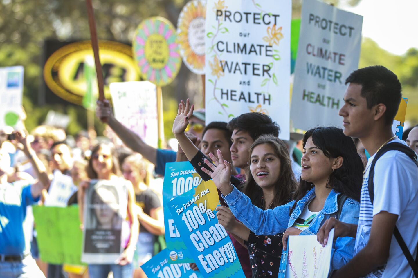 Students cheer and wave to cars honking in support as a large crowd of students gather in front of Mission Bay High School after they walked out of classes to participate in the Global Climate Strike in Pacific Beach on Friday, September 20, 2019 in San Diego, California.