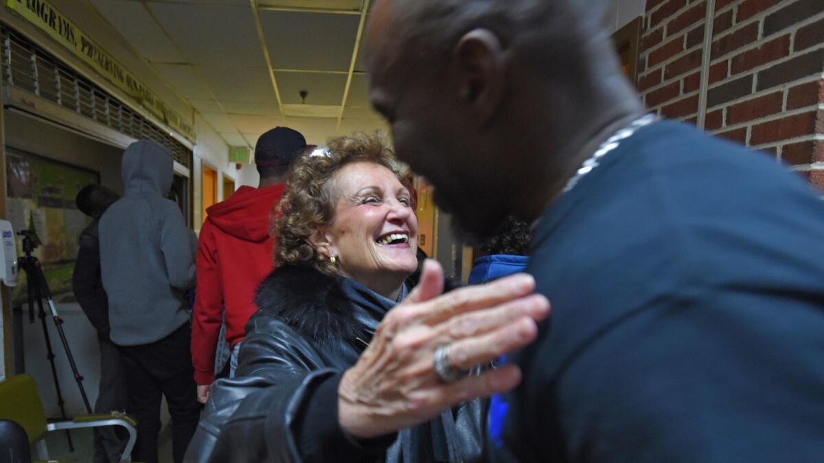 Councilwoman Rochelle "Rikki" Spector hugs Melvin Willingham, who runs the Makings of a Man mentorship program at the Samuel F.B. Morse Recreation Center in Baltimore.