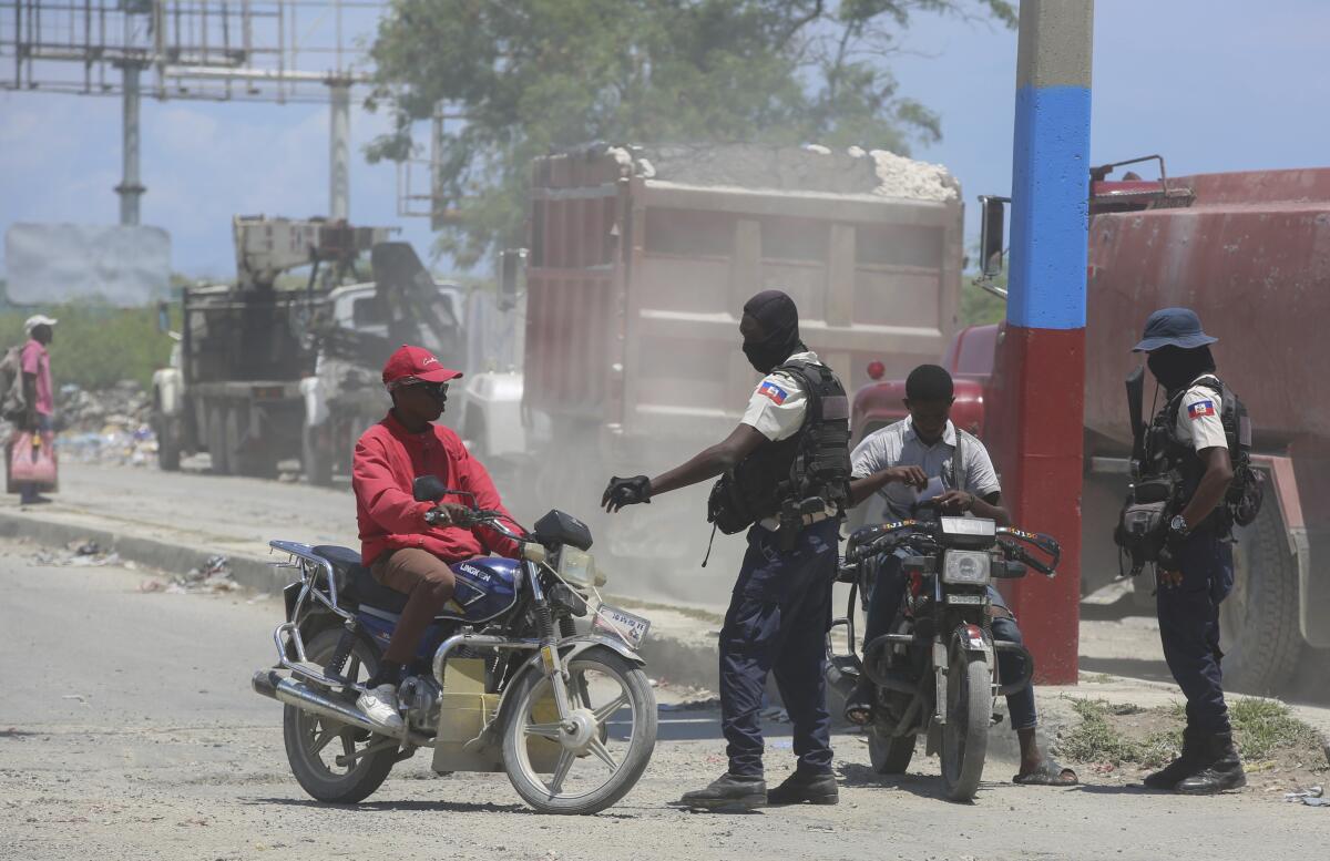Police check motorcyclists near the airport in Port-au-Prince, Haiti.