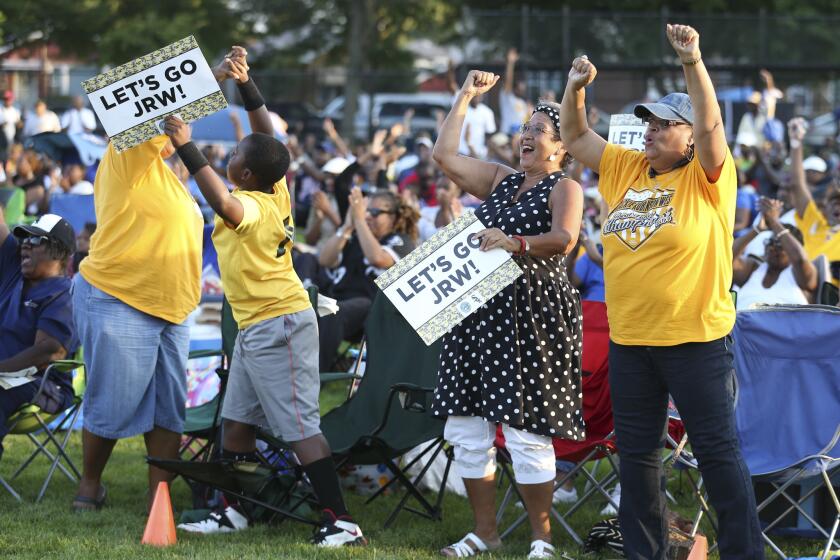 Left to right, front row fans, Felicia Bell, her son Joshua Bell, 10, Saundra Bishop (cq), and Cheryl Patterson, cheer the Jackie Robinson West team during a watch party, at Jackie Robinson Park, at 10540 S. Morgan Park St., in Chicago.