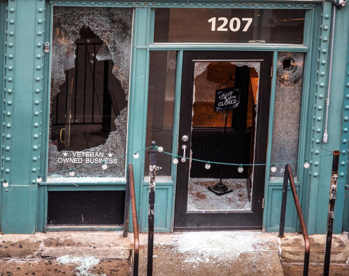 A bar in ruins, full of broken glass, after a night of protests that culminated in a shooting.