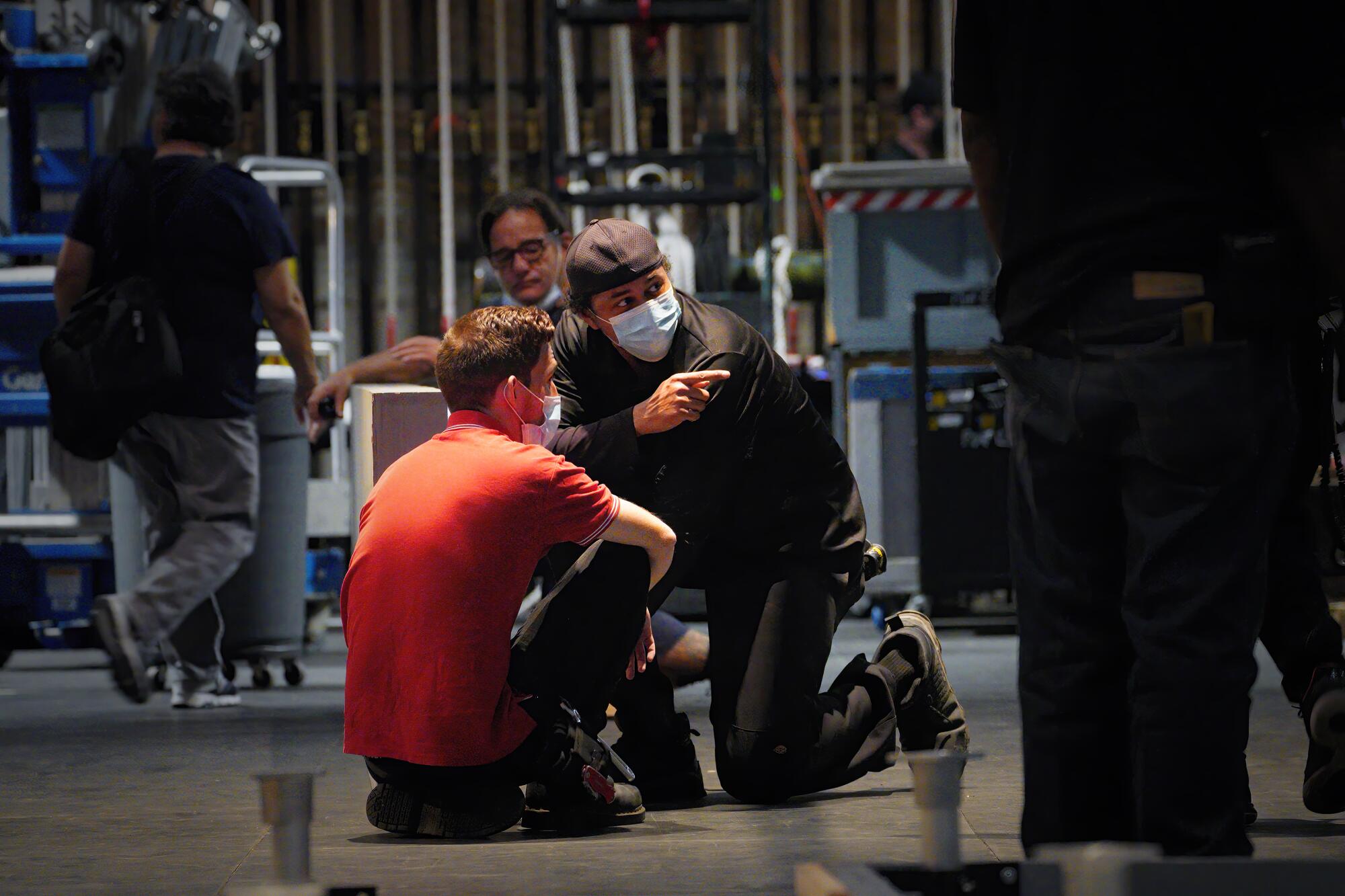 Crew of stagehands assemble the large stage platform.