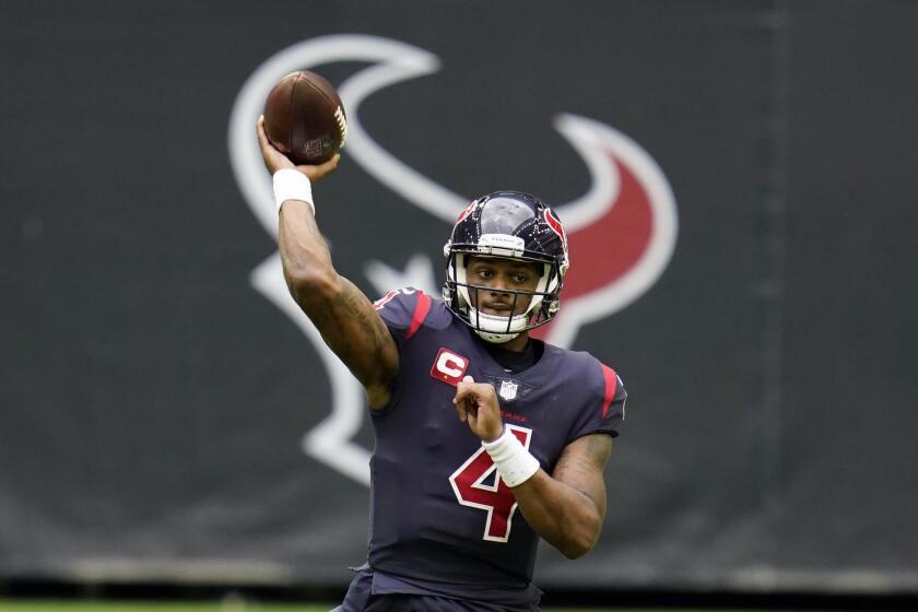 Houston quarterback Deshaun Watson throws a pass in front of the Texans logo