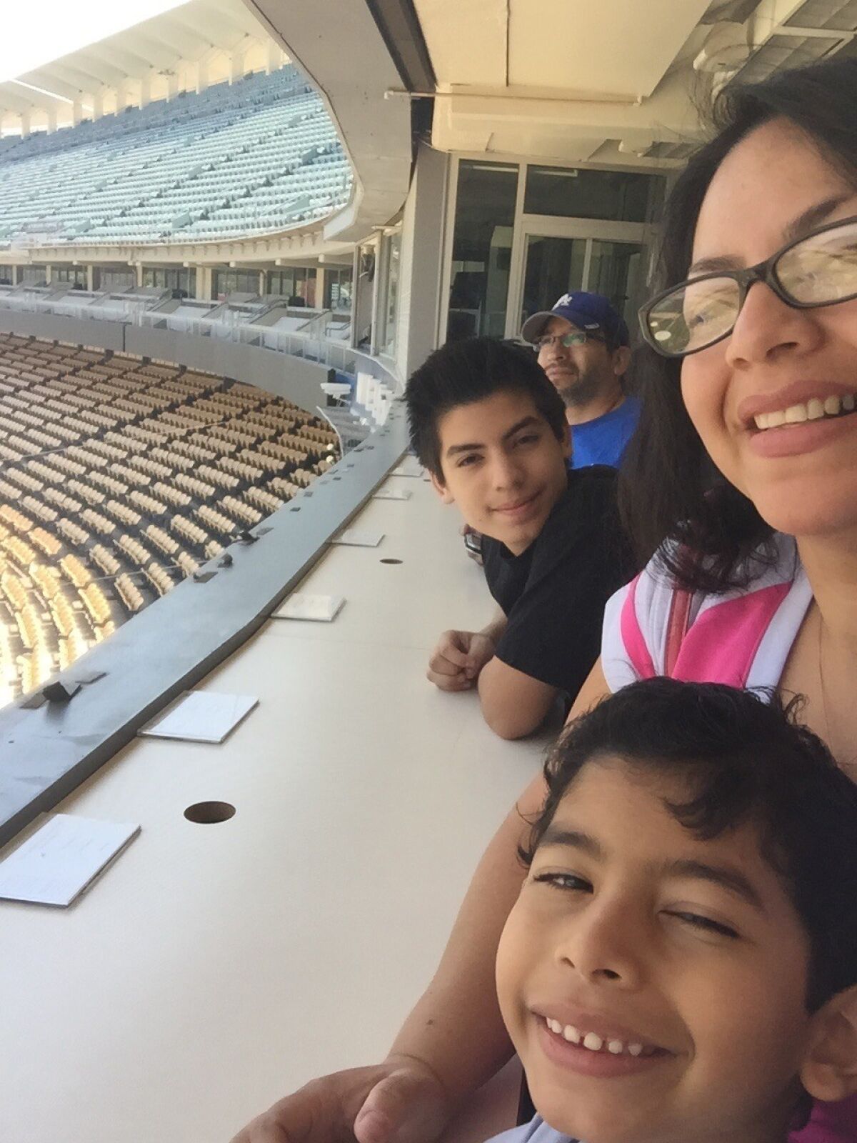 Jose Becerra, top, with his wife Maria Vallejo-Becerra and their two sons, Joshua and Julian, celebrating his 49th birthday with a stadium tour.