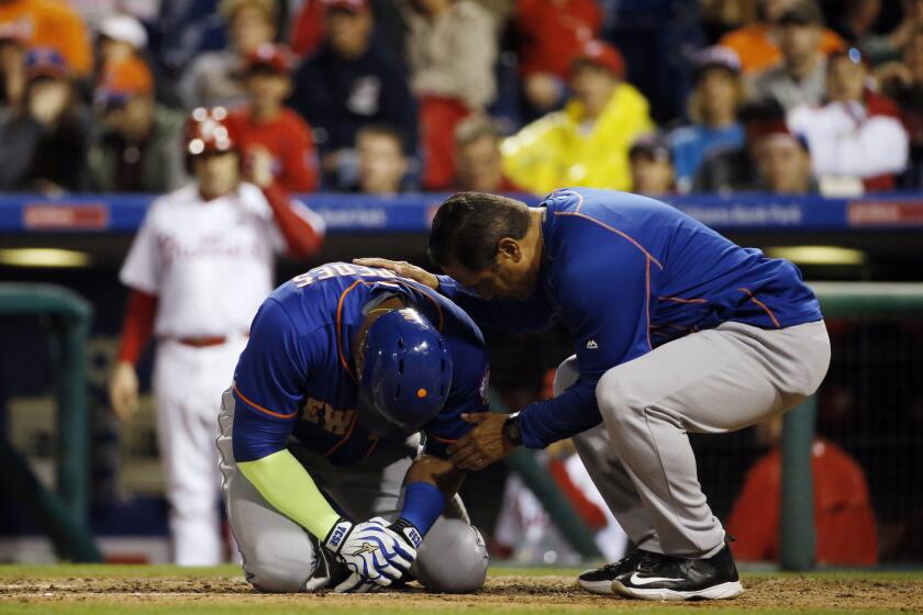 New York Mets slugger Yoenis Cespedes reacts after being hit by a pitch from the Philadelphia Phillies' Justin De Fratus during the third inning of a game Wednesday.