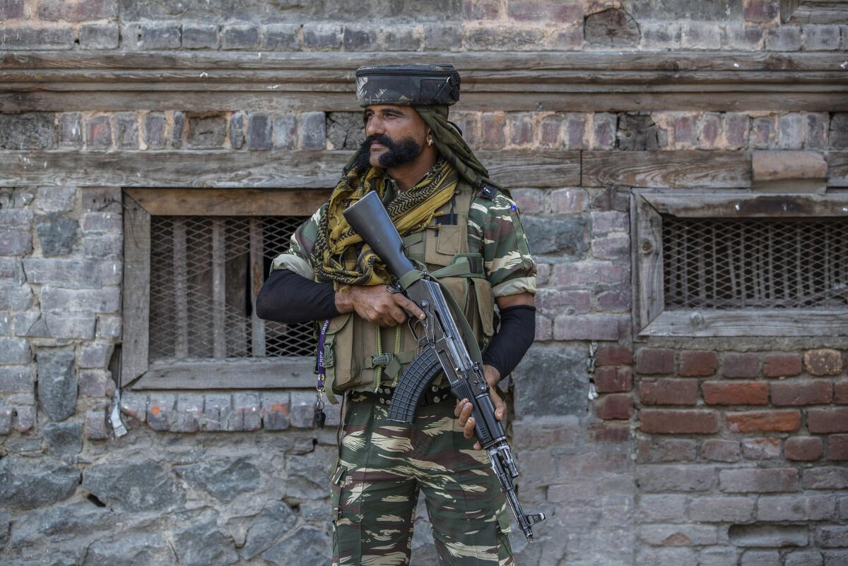 An Indian paramilitary soldier guards a deserted street in Srinagar, Indian controlled Kashmir, Sunday, Sept. 5, 2021. Authorities Sunday eased some restrictions that had been imposed after the death of top resistance leader Syed Ali Geelani. However, most shops and businesses stayed closed as government forces patrolled roads and streets in the city. (AP Photo/Mukhtar Khan)