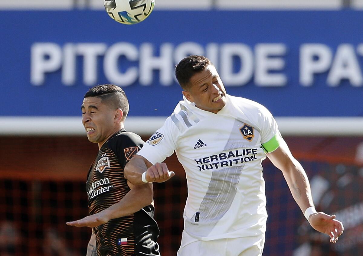 Dynamo midfielder Matías Vera, left, and Galaxy forward Javier "Chicharito" Hernández battle for the ball in a 1-1 draw Feb. 29, 2020.