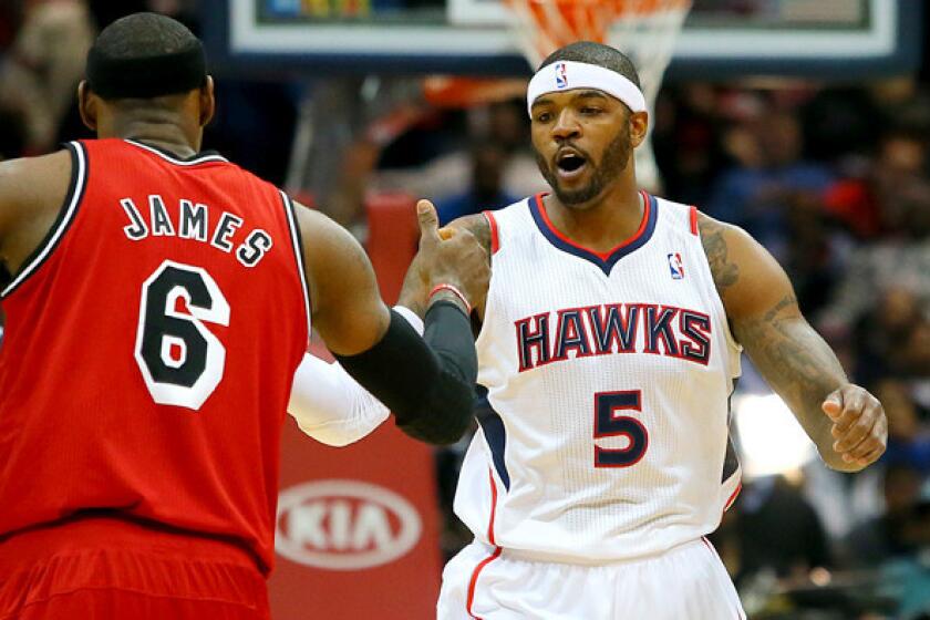 Josh Smith greets Heat forward LeBron James before the Hawks played Miami last season.