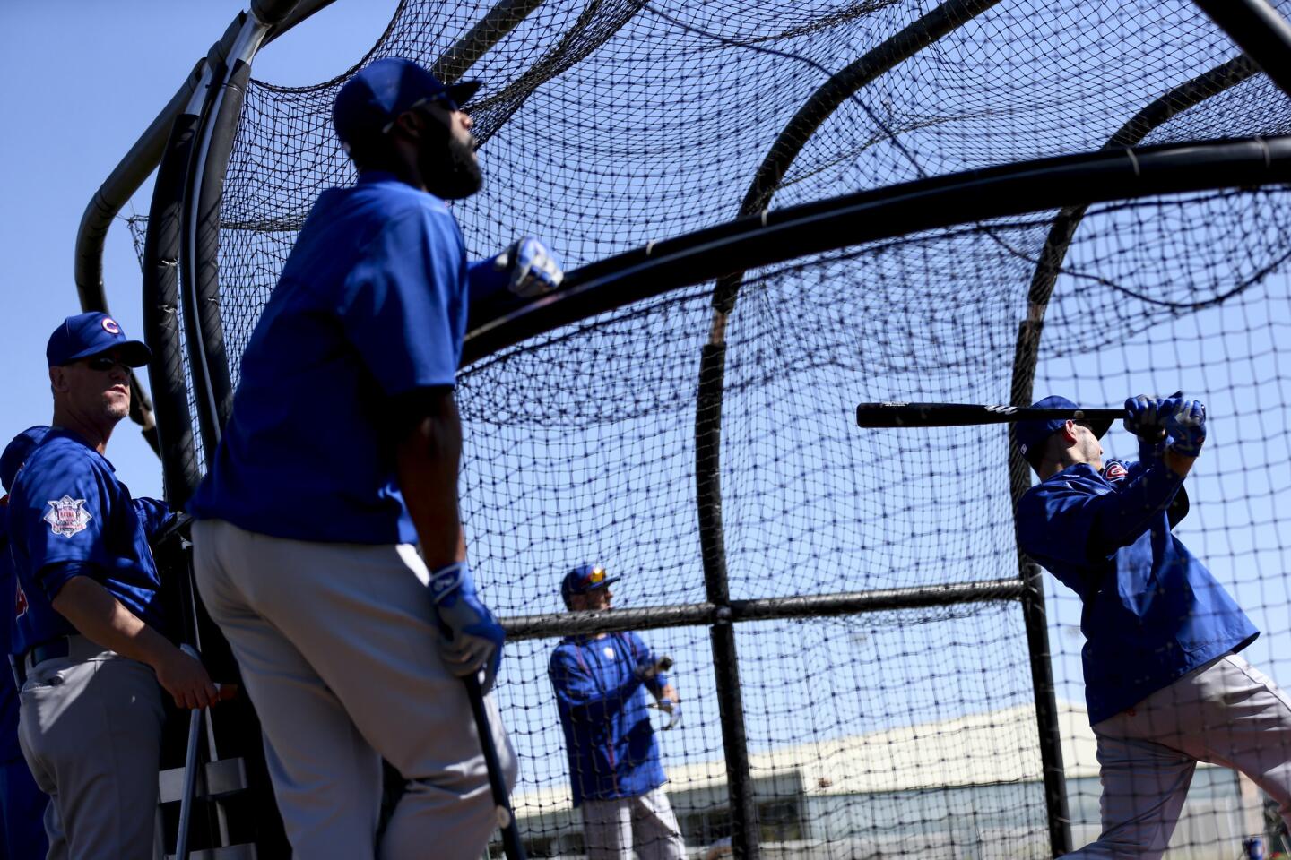 Cubs players watch Anthony Rizzo bat during spring training at Sloan Park Friday, Feb. 26, 2016, in Mesa, Ariz.