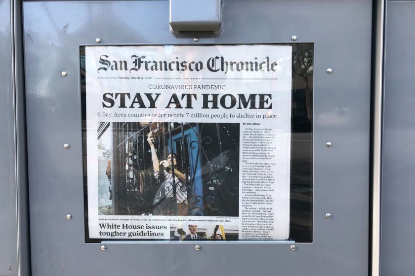 A news stand in Millbrae, Calif. displays the front page of the San Francisco Chronicle on Tuesday, March 17, 2020.