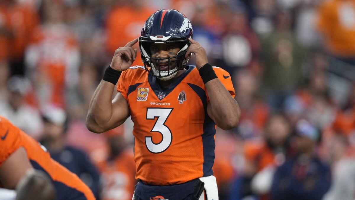 Denver Broncos quarterback Russell Wilson gestures during a game.