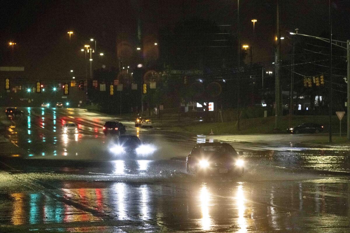 Car travel through floodwaters on Montgomery highway Wednesday, Oct. 6, 2021, near the Riverchase Galleria complex in Birmingham, Ala. (AP Photo/Vasha Hunt)