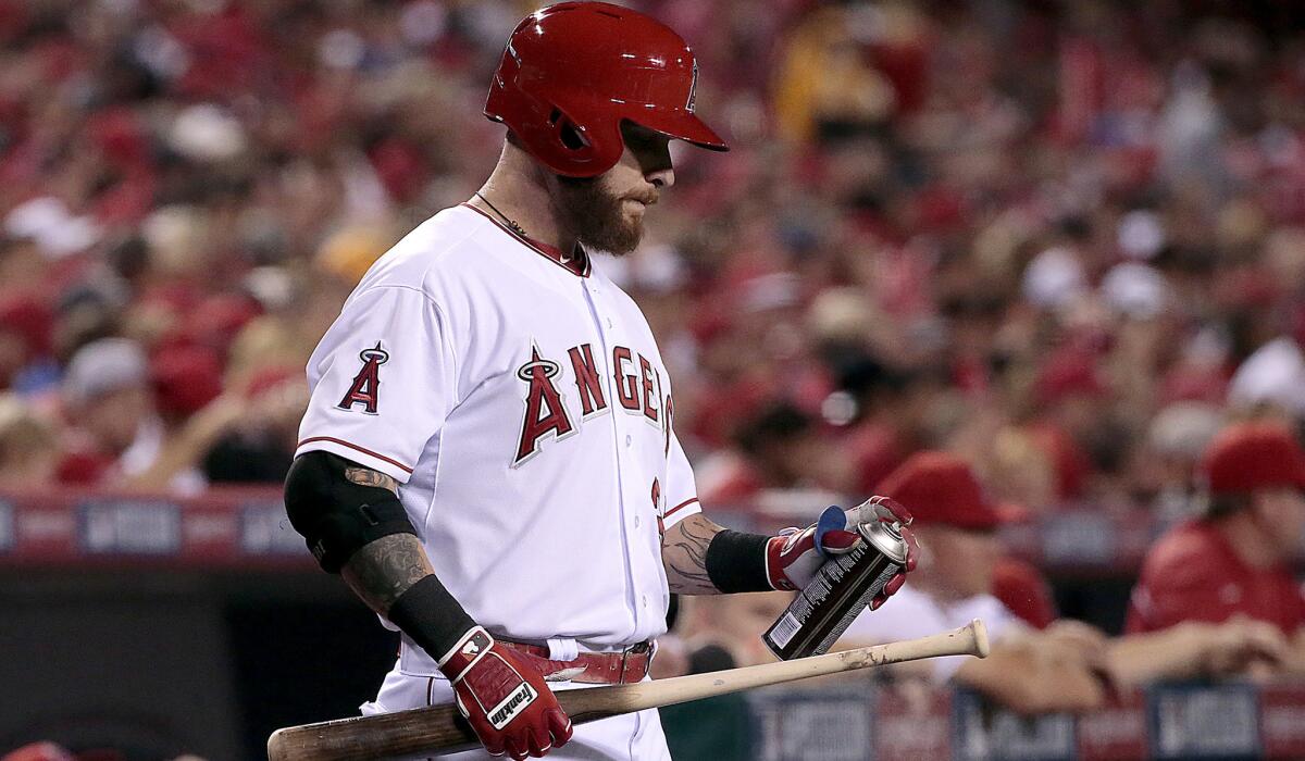 Angels outfielder Josh Hamilton sprays his bat handle as he prepares for an at-bat against the Royals in the playoffs last season.