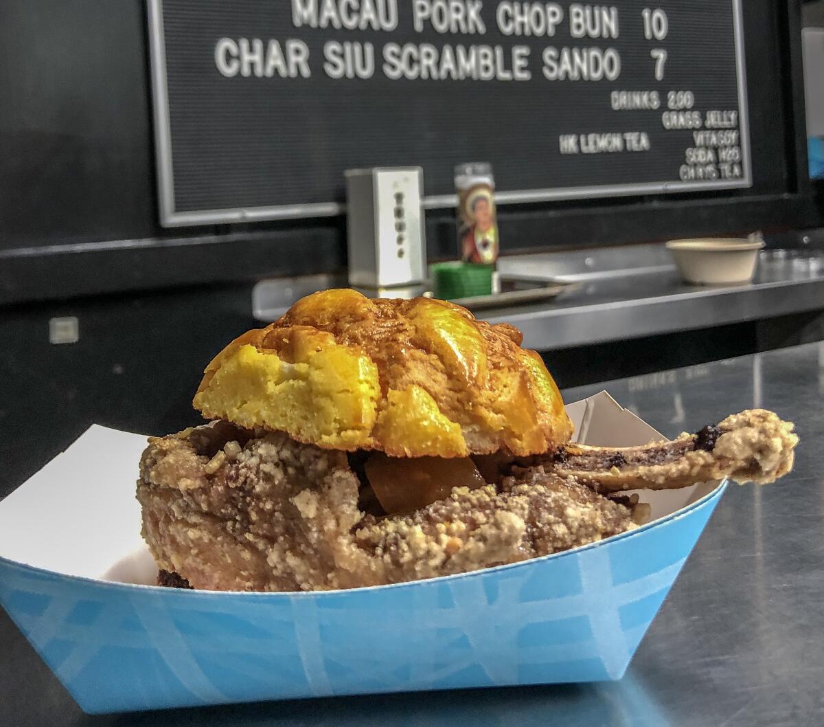 Pork chop on a pineapple bao at Pearl River Deli. 