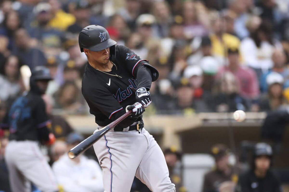 Miami Marlins' Joe Dunand hits a solo home run against San Diego Padres' Sean Manaea in the third inning of a baseball game Saturday, May 7, 2022, in San Diego. The home run was Dunand's first career hit. (AP Photo/Derrick Tuskan)