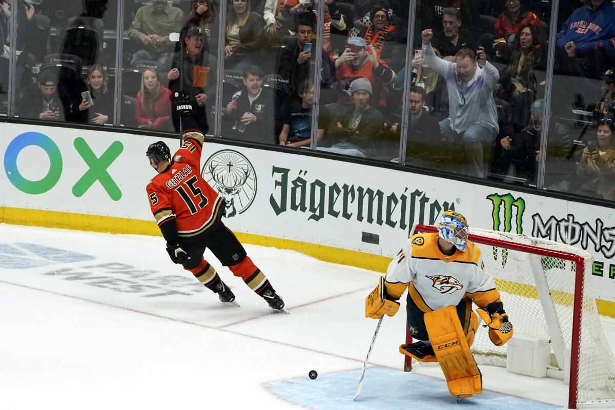 Ducks captain Ryan Getzlaf, left, celebrates after scoring the winning goal past Nashville Predators goaltender Juuse Saros.