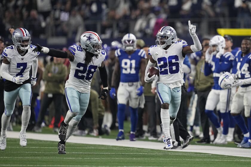 Dallas Cowboys' DaRon Bland (26) reacts after an interception during the second half of an NFL football game against the Indianapolis Colts, Sunday, Dec. 4, 2022, in Arlington, Texas. (AP Photo/Tony Gutierrez)