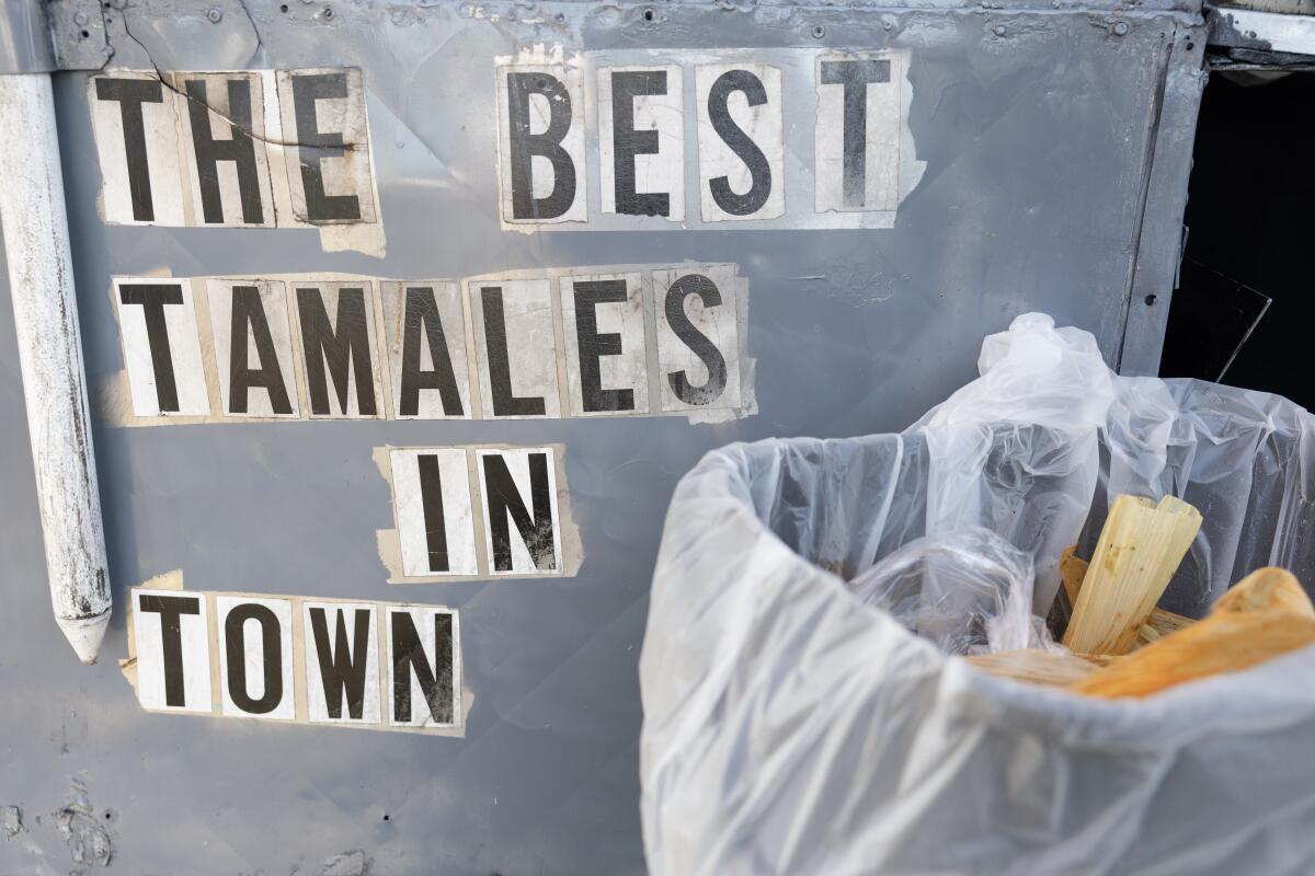 Reading on the side of the food cart "The best tamales in town."