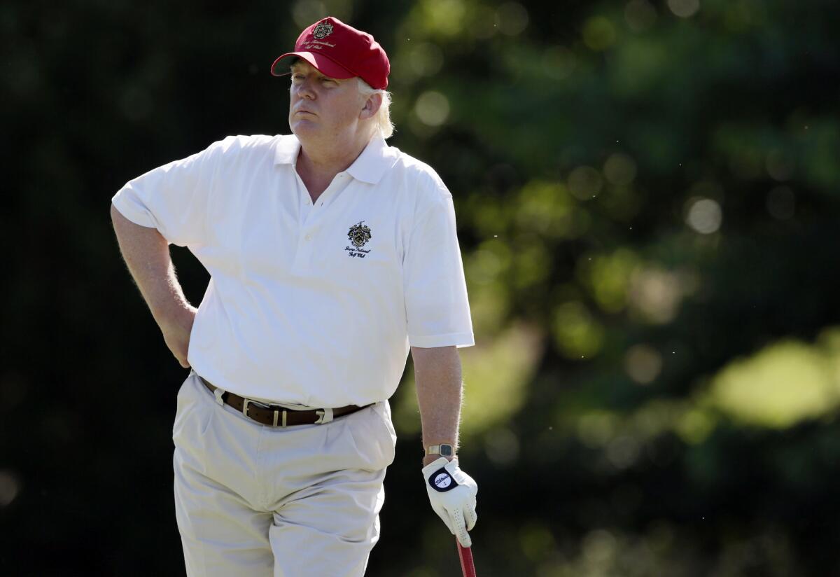 Donald Trump waits to his approach shot at No. 14 during the pro-am event at the AT&T National at Congressional Country Club in Bethesda, Md., on June 27, 2012.