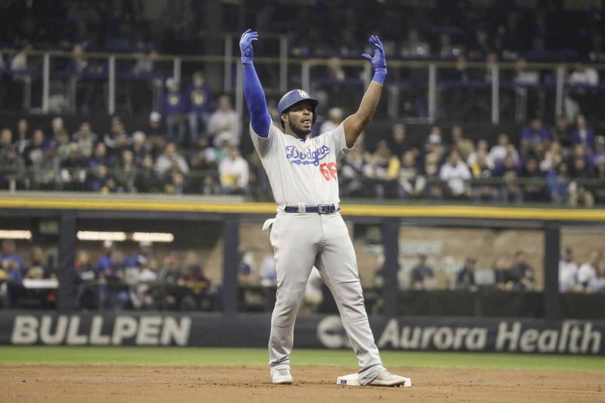 The Dodgers' Yasiel Puig celebrates hitting a second-inning double in Game 7 of the NLCS against the Milwaukee Brewers.