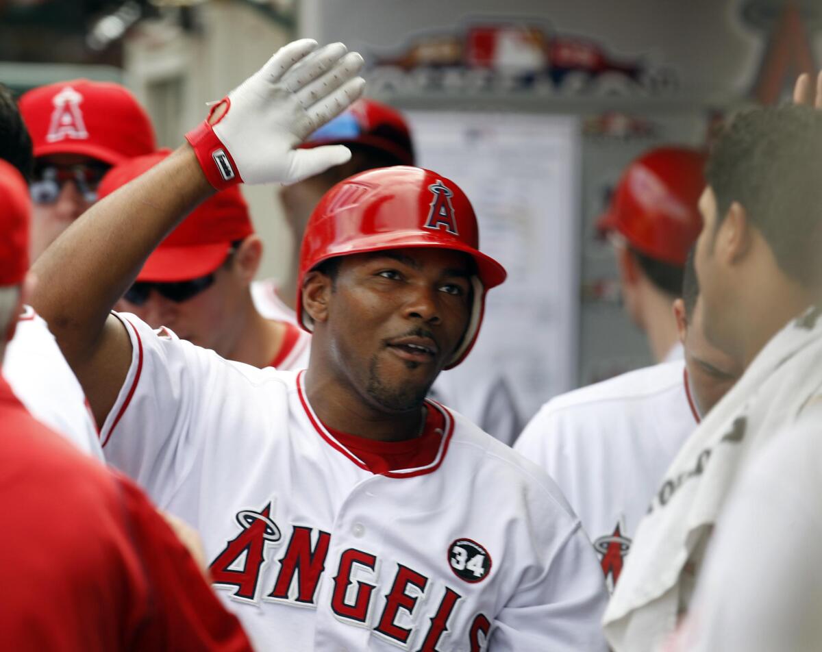 Angels second baseman Howie Kendrick celebrates with teammates after hitting a solo home run against the New York Yankees.