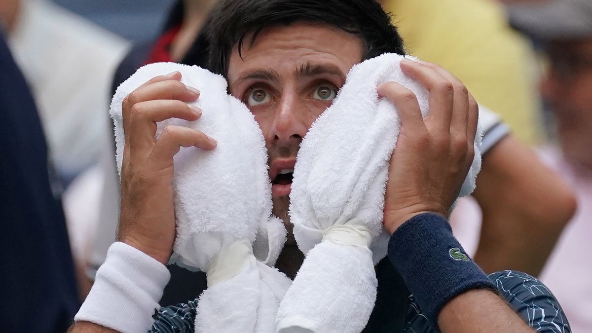 Novak Djokovic towels off in the heat against Marton Fucsovics during their U.S. Open men's singles match on Tuesday.
