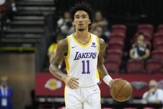 Los Angeles Lakers' Jalen Hood-Schifino drives up the court against the Golden State Warriors during the second half of an NBA summer league basketball game Friday, July 7, 2023, in Las Vegas. (AP Photo/John Locher)