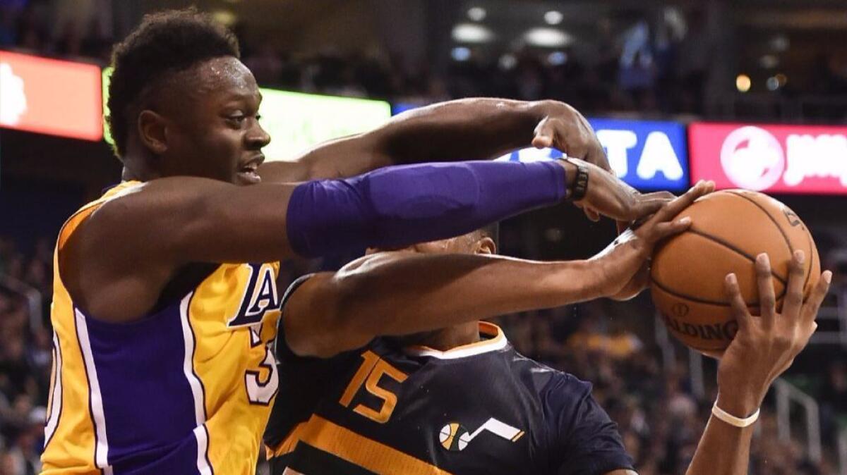 Lakers forward Julius Randle, left, fouls Jazz forward Derrick Favors during the second half of a game on Oct. 28.