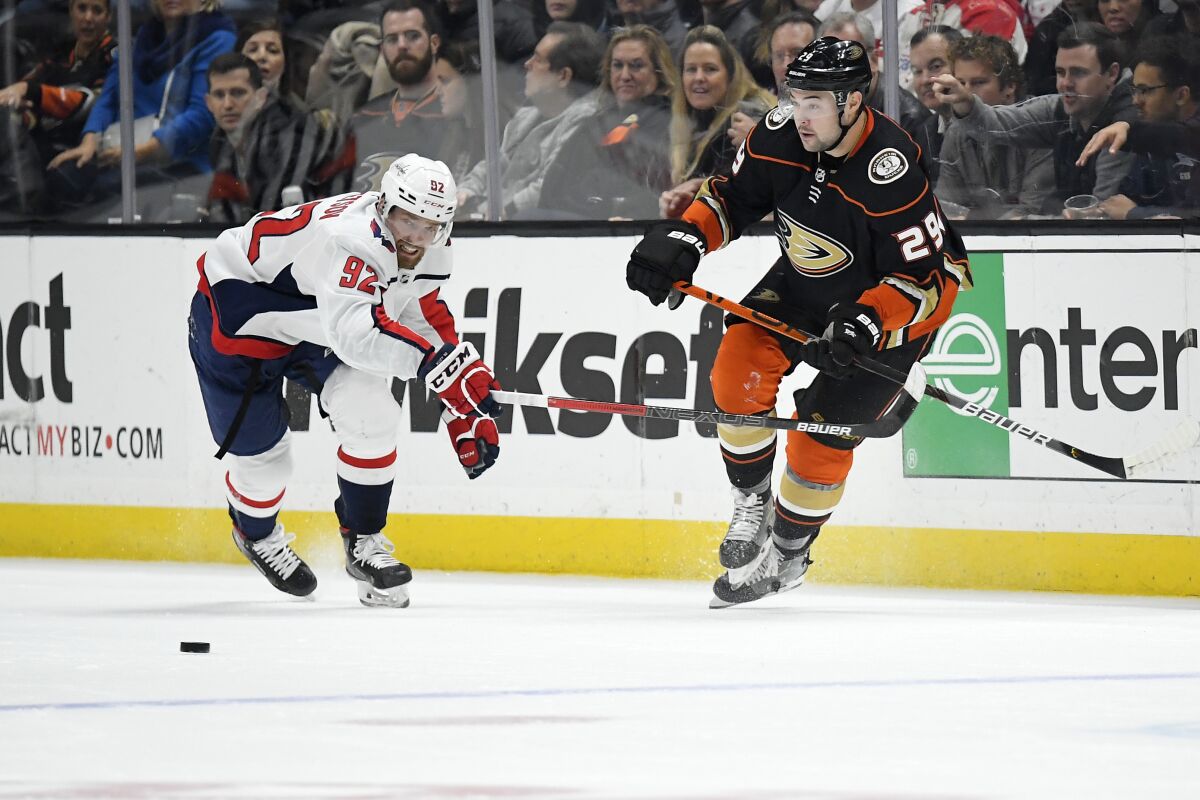 Washington Capitals center Evgeny Kuznetsov, left, and Ducks center Devin Shore compete for the puck during the second period on Friday at Honda Center.