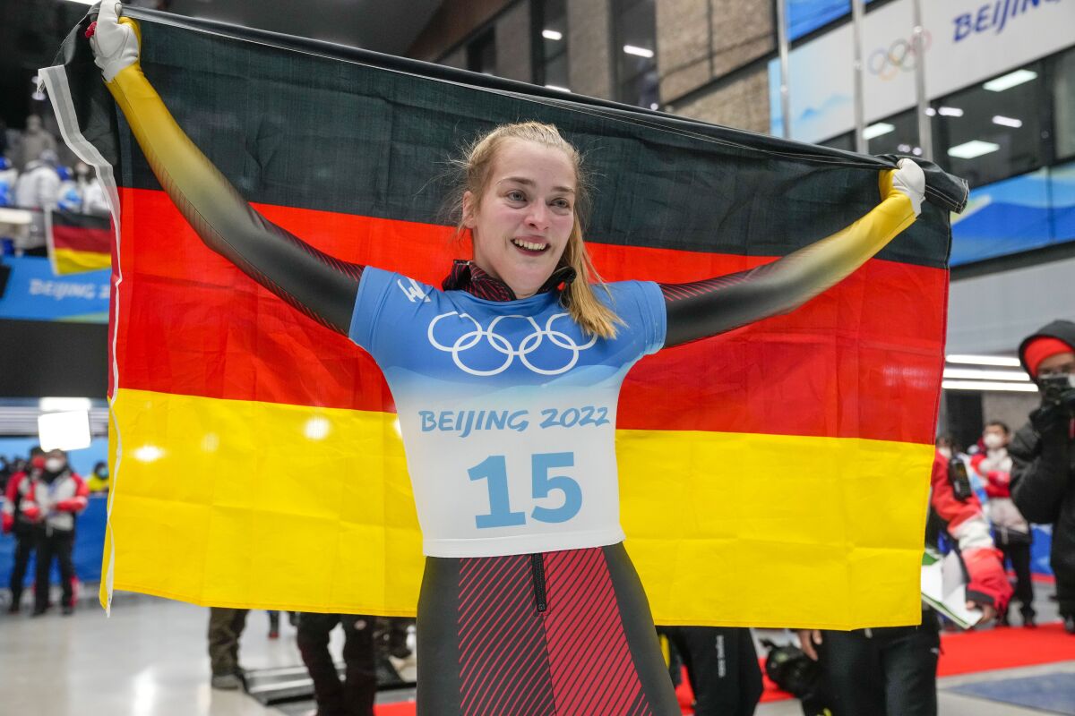 Hannah Neise, of Germany, celebrate winning the gold medal in the women's skeleton at the 2022 Winter Olympics, Saturday, Feb. 12, 2022, in the Yanqing district of Beijing. (AP Photo/Dmitri Lovetsky)